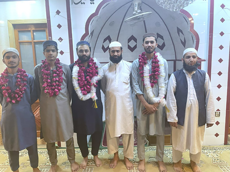 Devotees pose for group photo after Itikaf in a mosque as the Central Ruet-i-Hilal Committee Chairman Maulana Abdul Khabir Azad announces the sighting of Shawwal moon