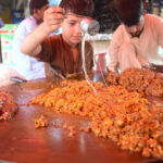 A young vendor preparing traditional food item for customers at Saddar