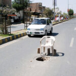 An opened manhole of sewerage system on a main road of the city posing threat to thousands of vehicles plying on this road. The management yet to take action to cover