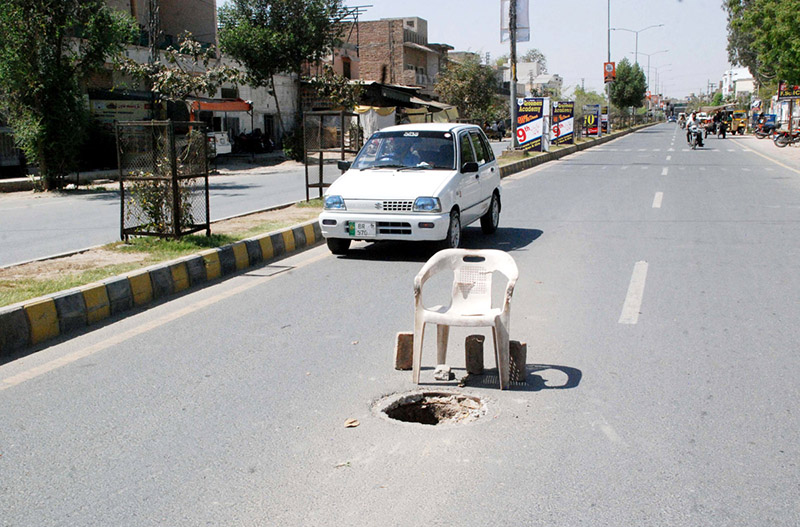 An opened manhole of sewerage system on a main road of the city posing threat to thousands of vehicles plying on this road. The management yet to take action to cover