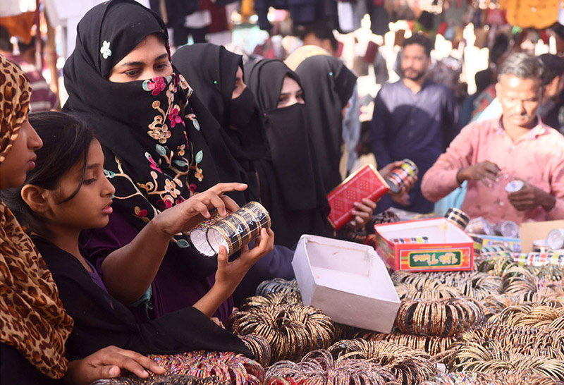 In connection with preparations for Eid-ul-Fitr, women are  selecting to buy bangles from the stalls set up in Bachat Bazar.