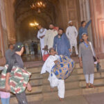 People receive the devotees after completing Itikaf outside a mosque in the last night of Ramadan