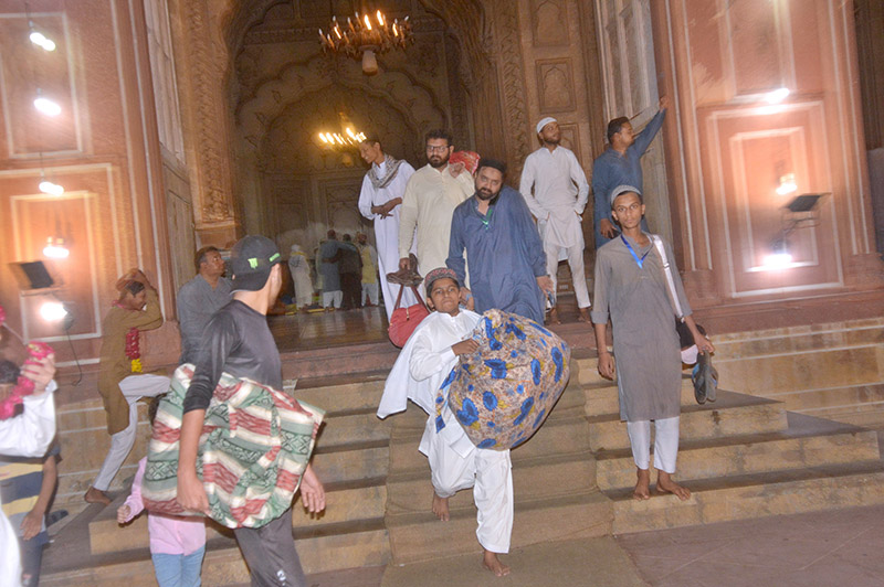 People receive the devotees after completing Itikaf outside a mosque in the last night of Ramadan