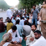 Volunteers serving food items for people in fast during Iftar in the holy Islamic fasting month of Ramzan ul Mubarak at road side