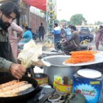 A vendor preparing traditional sweet item (Jalaibe) to sell at his roadside setup