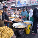 People buying Samose and Pakoday from a shop for Iftar