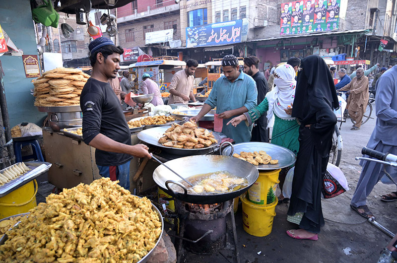 People buying Samose and Pakoday from a shop for Iftar
