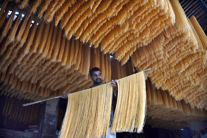 Worker busy in hanging the vermicelli for dry purpose at his workplace in connection with upcoming Eidul Fitr.
