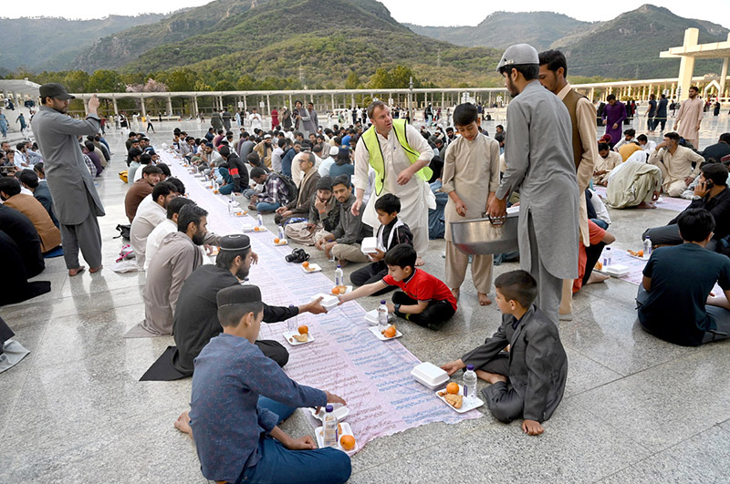 Volunteers arranging food items during Iftar for people in fast at Faisal Masjid in the federal capital