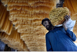 Worker busy in hanging the vermicelli for dry purpose at his workplace in connection with upcoming Eidul Fitr.