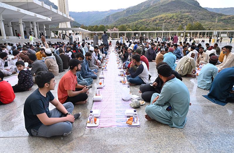 Volunteers arranging food items during Iftar for people in fast at Faisal Masjid in the federal capital