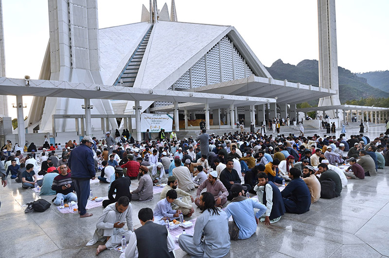 Volunteers arranging food items during Iftar for people in fast at Faisal Masjid in the federal capital