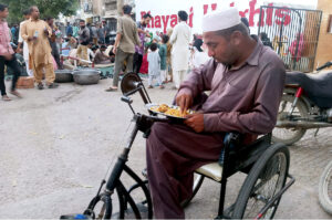 A special person on wheelchair break his fast during Iftar in the holy fasting month of Ramadan in city.