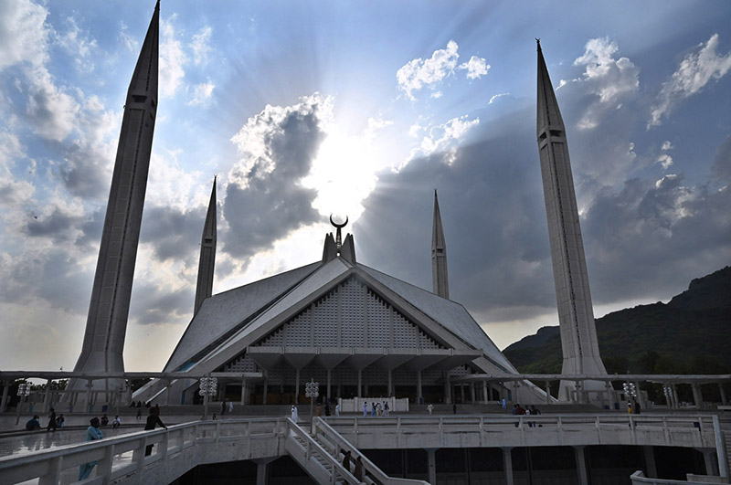 Dark clouds hovering over the Faisal Masjid before light rain in the federal capital