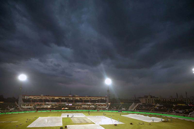 A view of the Pindi Cricket Stadium while in the background dark clouds hovering over the city