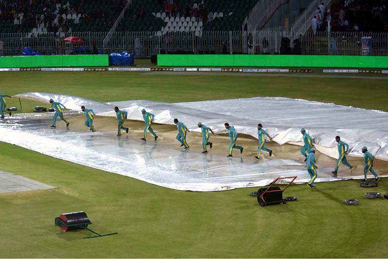 A view of the Pindi Cricket Stadium while in the background dark clouds hovering over the city