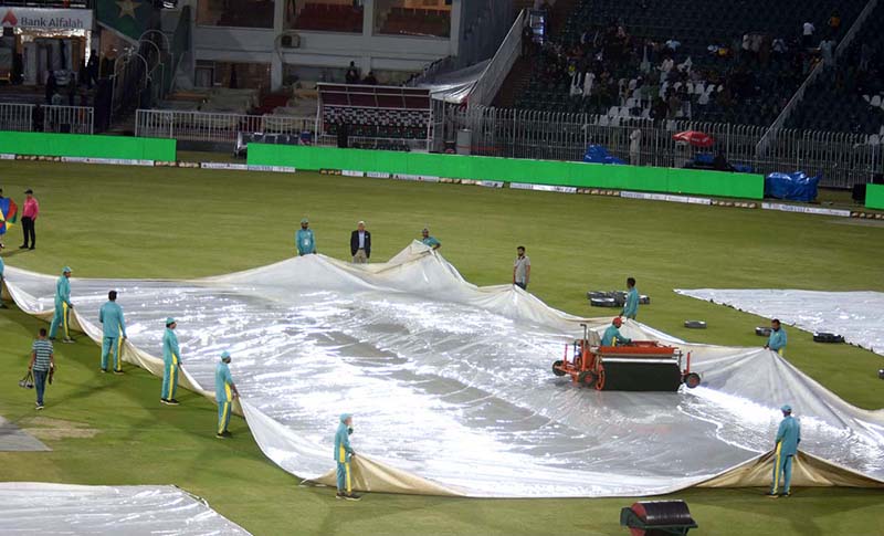 A view of the Pindi Cricket Stadium while in the background dark clouds hovering over the city