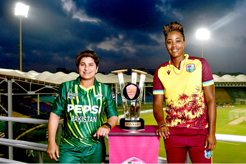 Pakistan Women’s Cricket Team Captain, Nida Dar and West Indies Cricket Team Captain Hayley Matthews pose with T20I trophy during unveiling ceremony at National Bank Studium