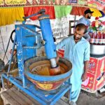 A vendor busy in preparing traditional summer drink (Sardai) for customers at his roadside setup in Federal Capital