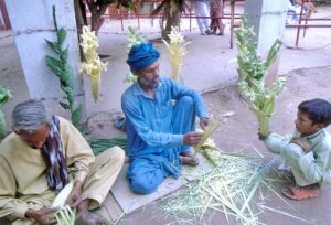 Workers busy in making decoration items with leaves at their setup to earn livelihood