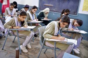 Students solving question paper during annual examination of SSC (part-I) (class IX) at Hayat Girls High School.