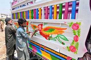 Painters busy in making painting on body of a delivery truck at Pirwadhai