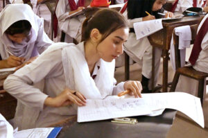 Students solving question paper during annual examination of SSC (part-I) (class IX) at Hayat Girls High School.