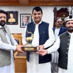 Chief Minister Gigilt-Baltistan Haji Gulbar Khan giving a shield to Federal Minister for Kashmir Affairs Ameer Muqaam
