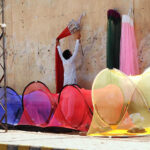 A vendor is busy displaying mosquito nets to attract customers at his roadside setup