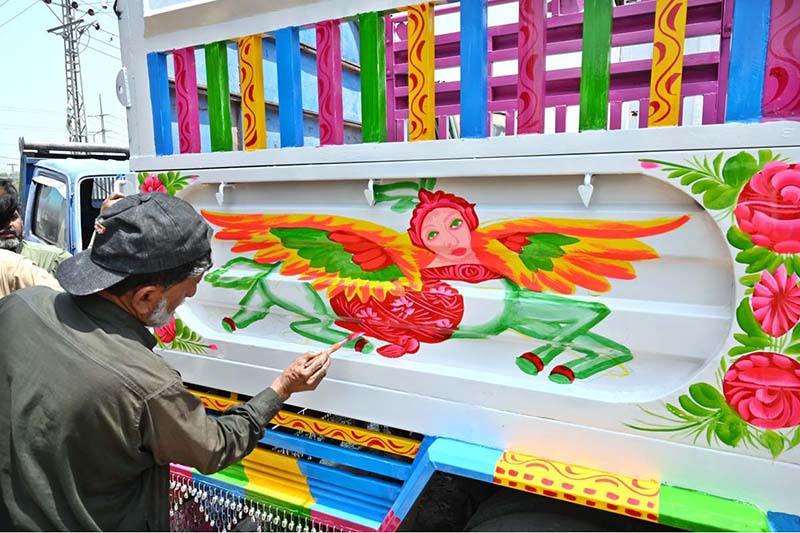 Painters busy in making painting on body of a delivery truck at Pirwadhai