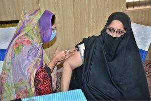 Staffers are administering preventive vaccination to the pilgrims at the Haji Camp Cooperative Training College.