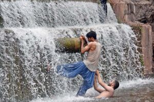 People bathing at Angoori Waterfall to get some relief from scorching hot weather in Federal Capital.
