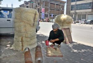 A worker busy in making ‘khas’ (to be used in room cooler) at Saidpur Road.