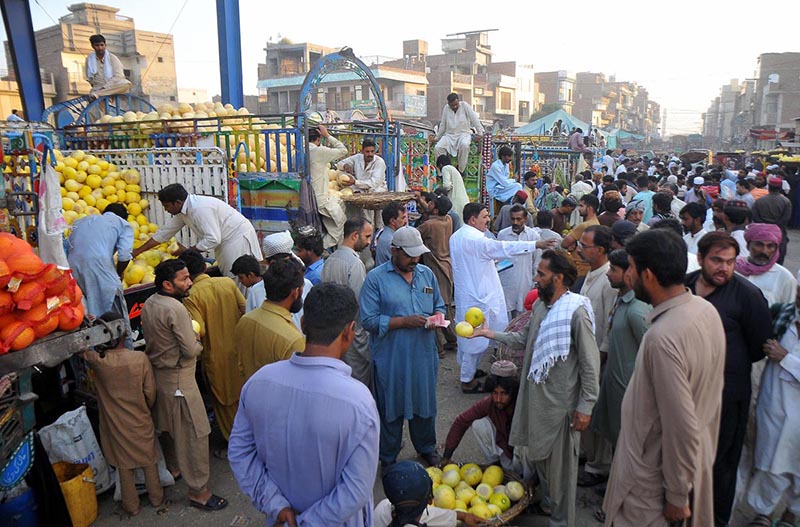 A large number of traders participating in bidding of seasonal fruit Melons at the Fruit market