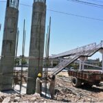 Labourers busy in construction work of flyover at under construction 10th Avenue during development work in Federal Capital