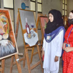 Students viewing paintings from different universities of South Punjab in the first South Punjab art exhibition competition organized by Women's University Multan.