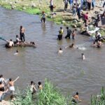 Youngsters jumping and bathing in nullah korang to get relief from scorching hot weather in Federal Capital.