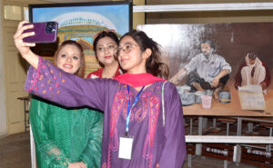 Students viewing paintings from different universities of South Punjab in the first South Punjab art exhibition competition organized by Women's University Multan.