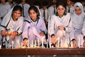 Students of APS observing candle vigil in memory of the victims of May 9 at Radio Pakistan.
