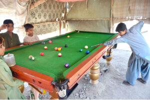Youngsters playing snooker at Makrani Para.