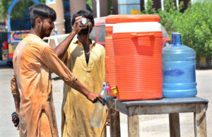 People drinking water from water cooler to crunch their thirst during hot weather in the city.