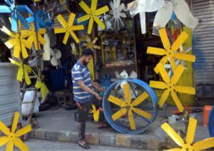 A worker busy in preparing air cooler fan blades at his workplace