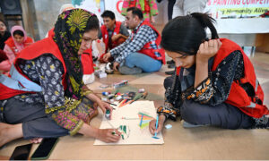 Students participating in Arts & Painting Competition under the theme "Keeping Humanity Alive" in connection with World Red Cross and Red Crescent Week Celebration at Citizen's Club, F-9 Park.