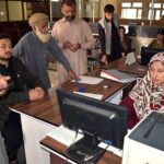 Police Khidmat Markaz staffer issuing online driving license to the customers in Ten District of GB