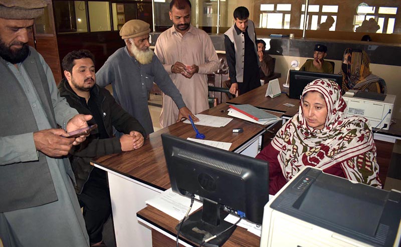 Police Khidmat Markaz staffer issuing online driving license to the customers in Ten District of GB