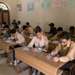 Students solving question paper during annual examination of SSC (part-I) at Naval Rai Hiranand High School