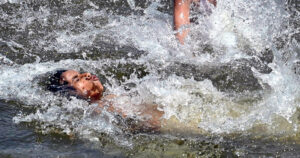 A youngster enjoy swimming in canal to get some relief from hot weather in Federal Capital.