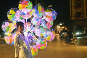 A street vendor displaying balloons to attract the customers at Latifabad.