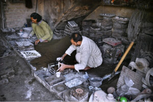 Workers making different parts from iron die at his work place at goods Naka area