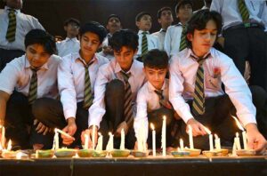 Students of APS observing candle vigil in memory of the victims of May 9 at Radio Pakistan.